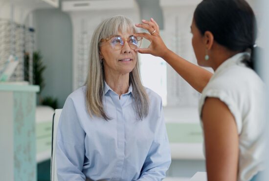 femme de 50 ans chez l'opticien qui essaie une paire de lunette